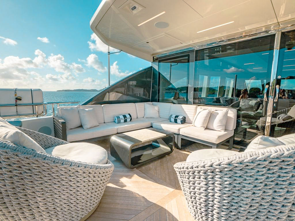 Bow of the 90 Ocean Alexander yacht at sunset with seating area and hot tub