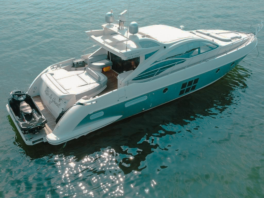 Luxurious 62ft Azimut yacht cruising the clear waters of Miami for a private charter.
