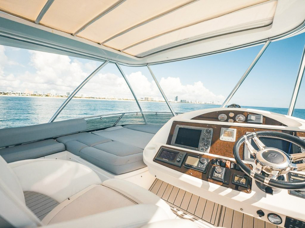 A group enjoying the bow sunpad of 70 Sunseeker II yacht in Miami