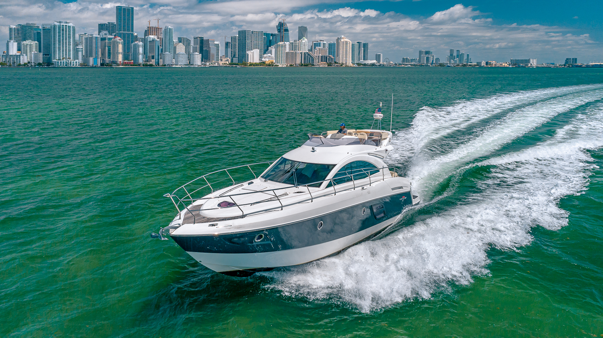 Interior master cabin of the 52 Beneteau yacht with comfortable bed and bright windows