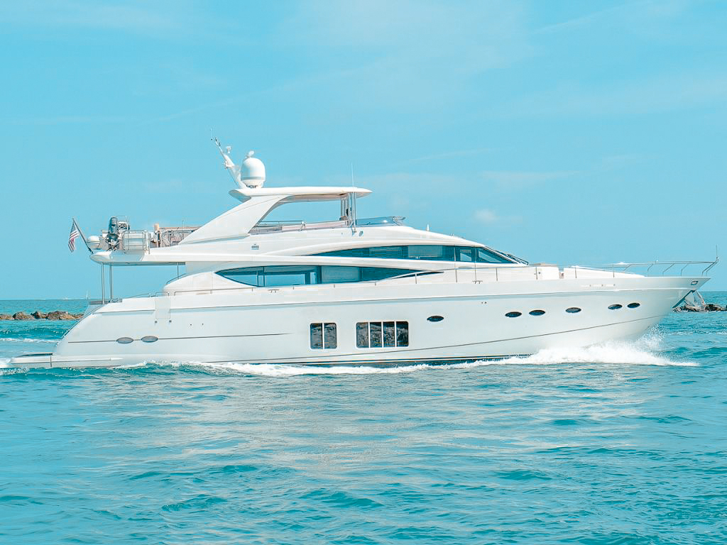 Luxurious 88ft Princess yacht sailing on turquoise waters in Miami under a sunny sky.