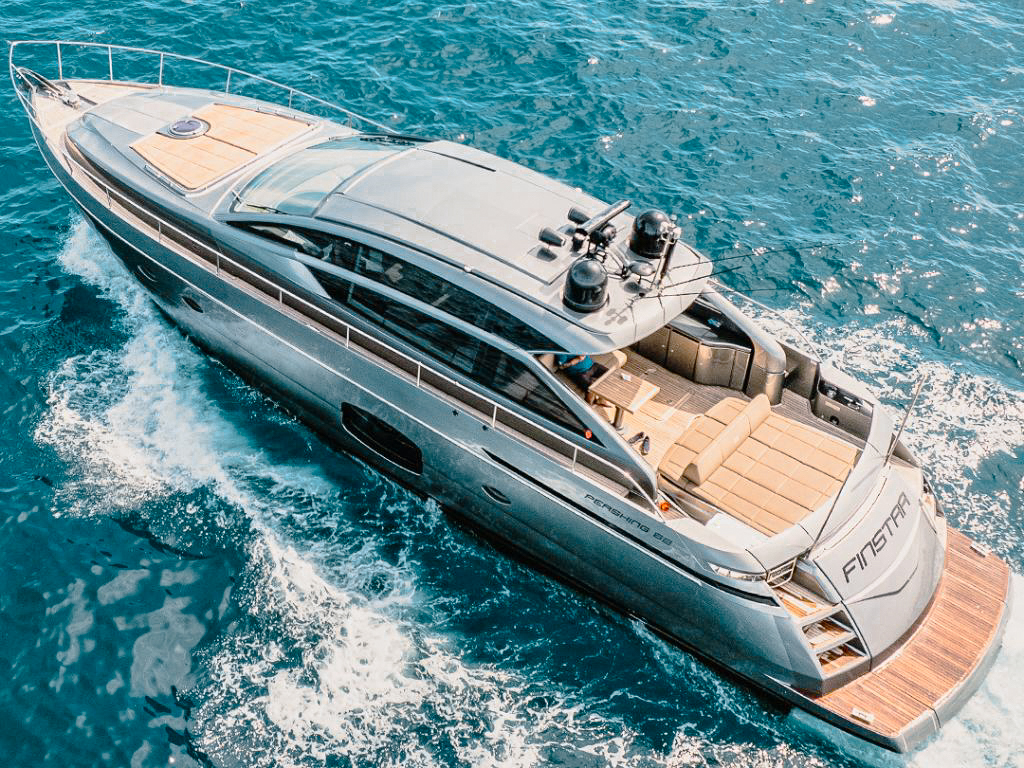 Elegant white 62ft Pershing yacht cruising in bright blue Miami waters.