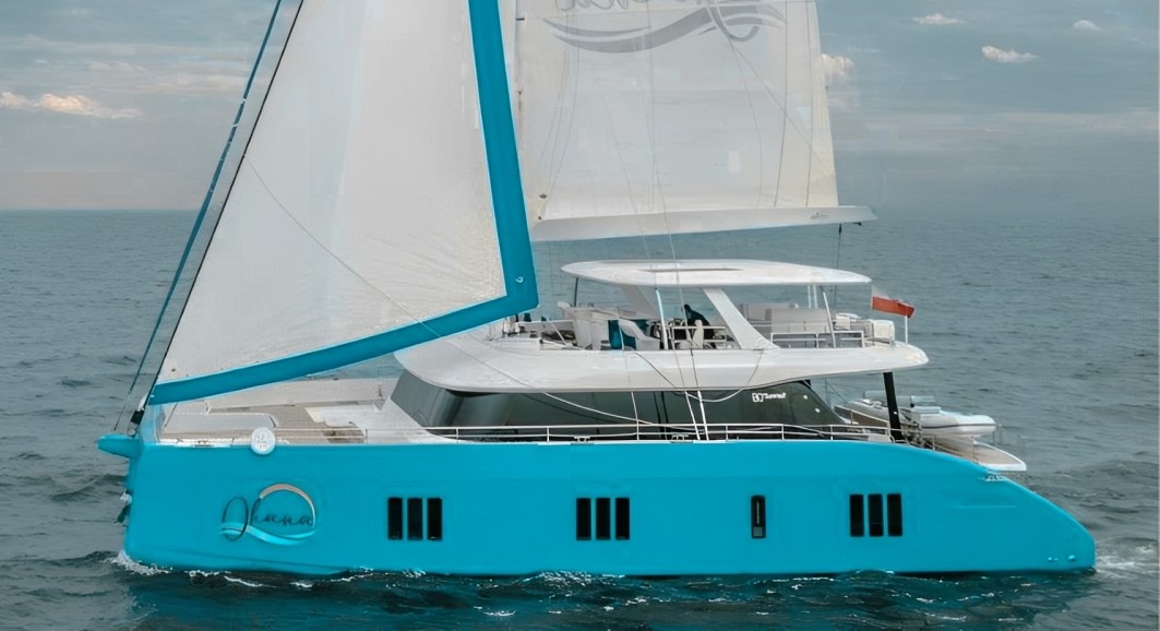 Luxurious 80ft Sunreef V yacht sailing in the crystal-clear Caribbean waters under the sun.