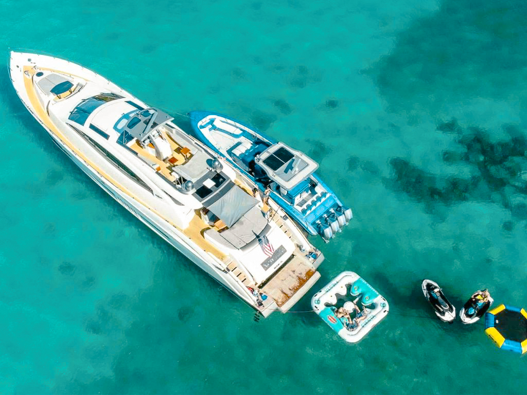 Rear view of the 92 Lazarra yacht with a swimming platform and tender onboard