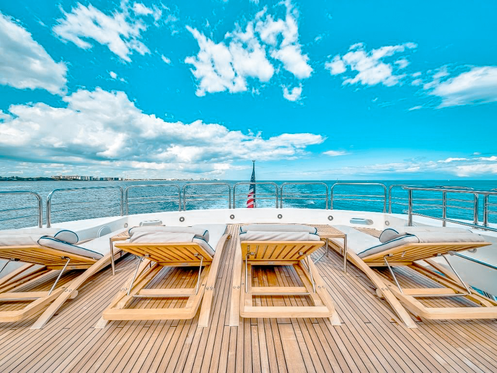 Upper deck with seating and sunbathing area on the 131 Sunseeker yacht