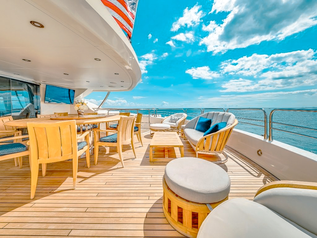 Couple enjoying a luxury sunset yacht cruise with champagne during golden hour.