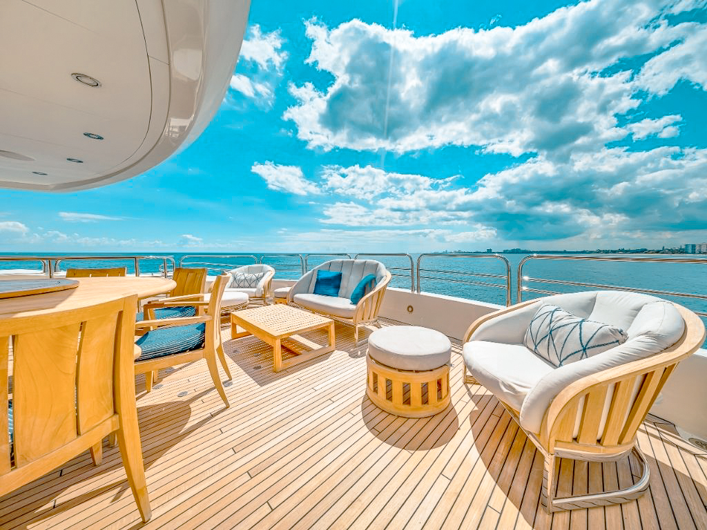 Luxury yacht cruising sparkling turquoise waters off the coast of Miami skyline