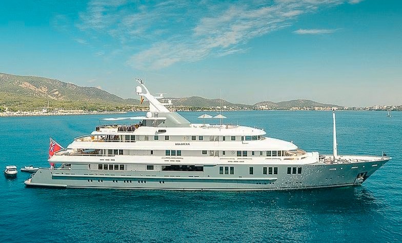 Luxurious 251ft Amels yacht cruising the turquoise waters of the Caribbean island.