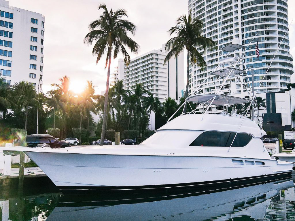 Stunning 70ft Hatteras yacht ready for charter in Miami's clear blue waters.
