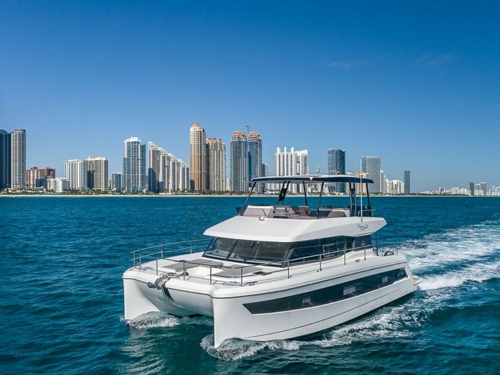 Side view of the 53 Fountaine Pajot catamaran cruising in Miami