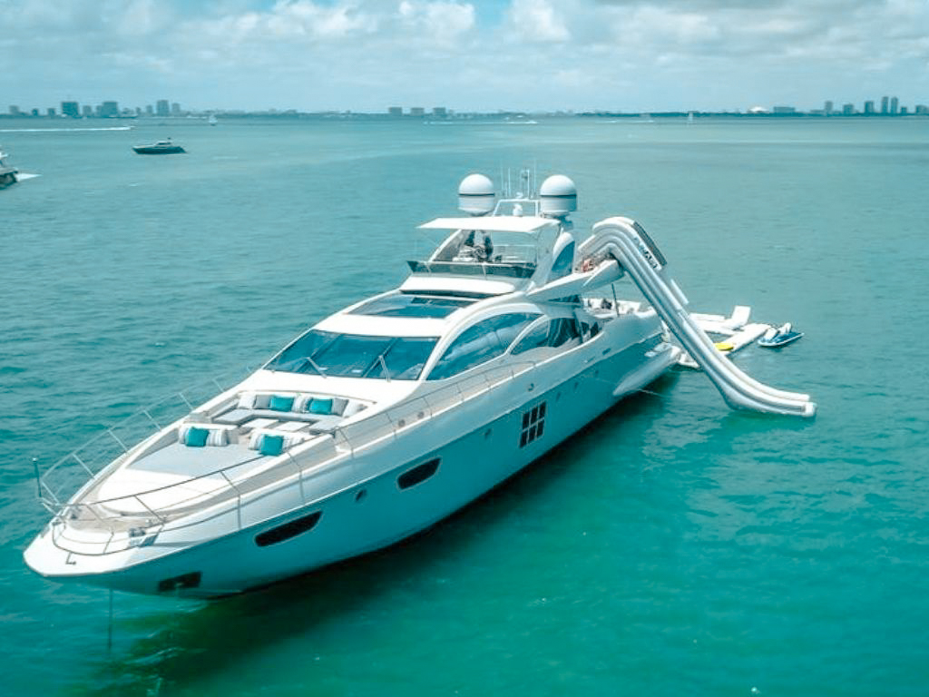 A guest enjoying the water slide from the 103 Azimut II yacht