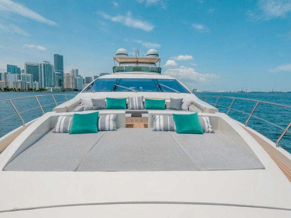A guest floating on an inflatable flamingo near the 103 Azimut II yacht