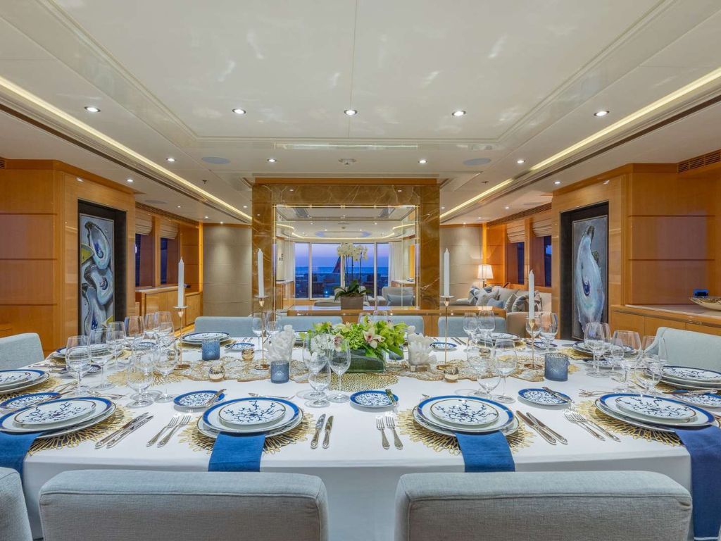 180 Heesen yacht at sunset in The Bahamas, showing spacious deck