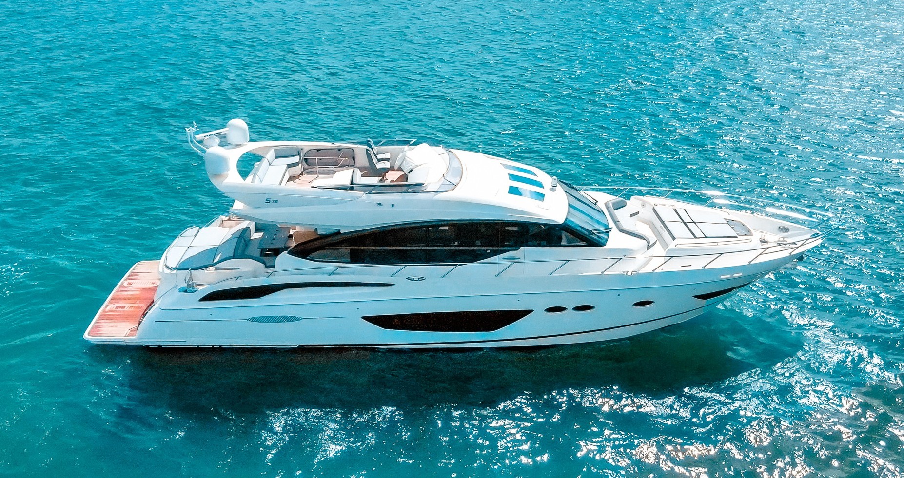 Stunning 74ft Princess yacht cruising in Miami waters, available for charter
