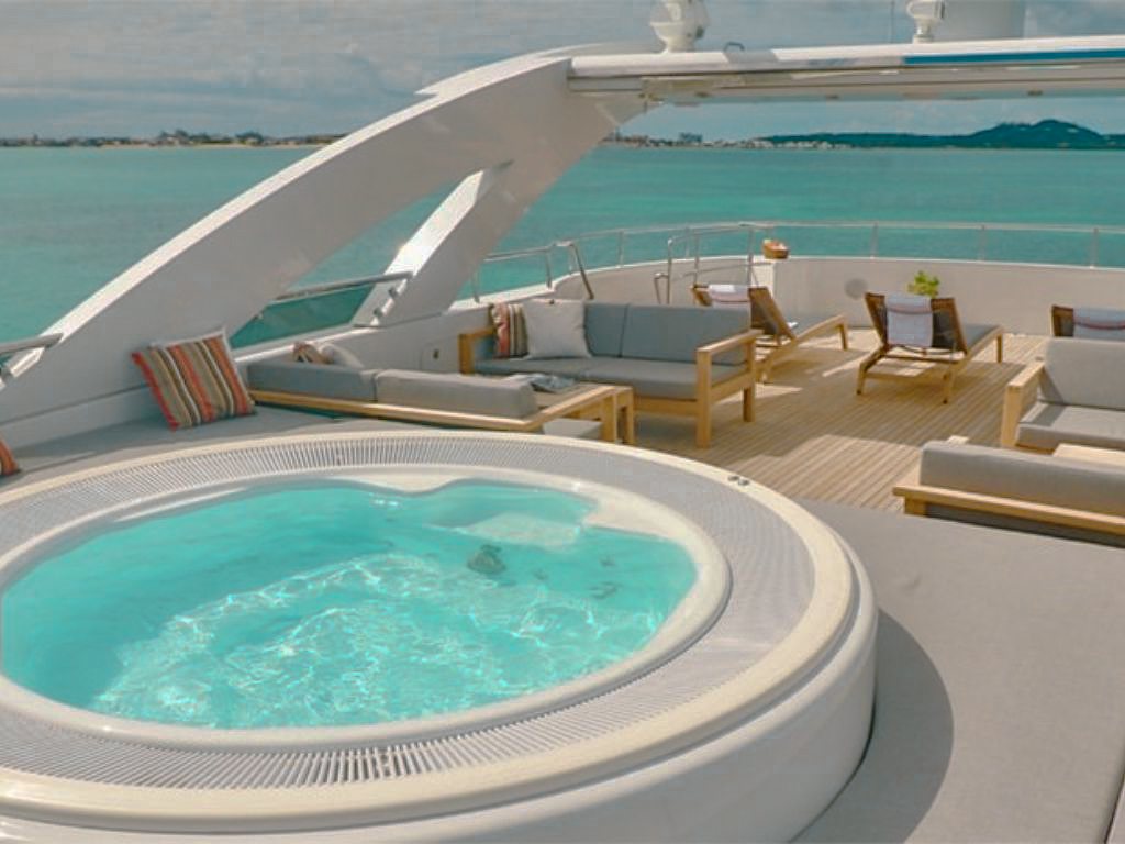 people relaxing on the front deck of the 144 Heesen yacht