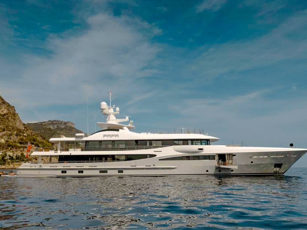 Luxurious Amels 180ft yacht sailing in the clear turquoise waters of the Caribbean.