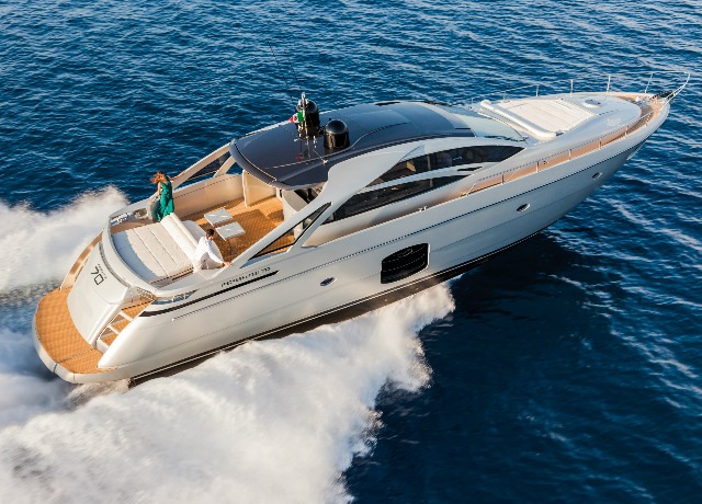 The luxurious 70ft Pershing yacht cruising along the stunning Italian coast on a sunny day.