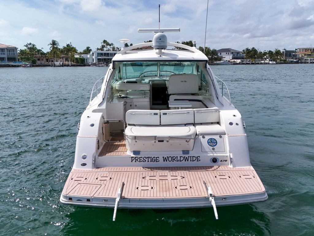 Deck of the 47 Sea Ray yacht with seating and Miami skyline in background