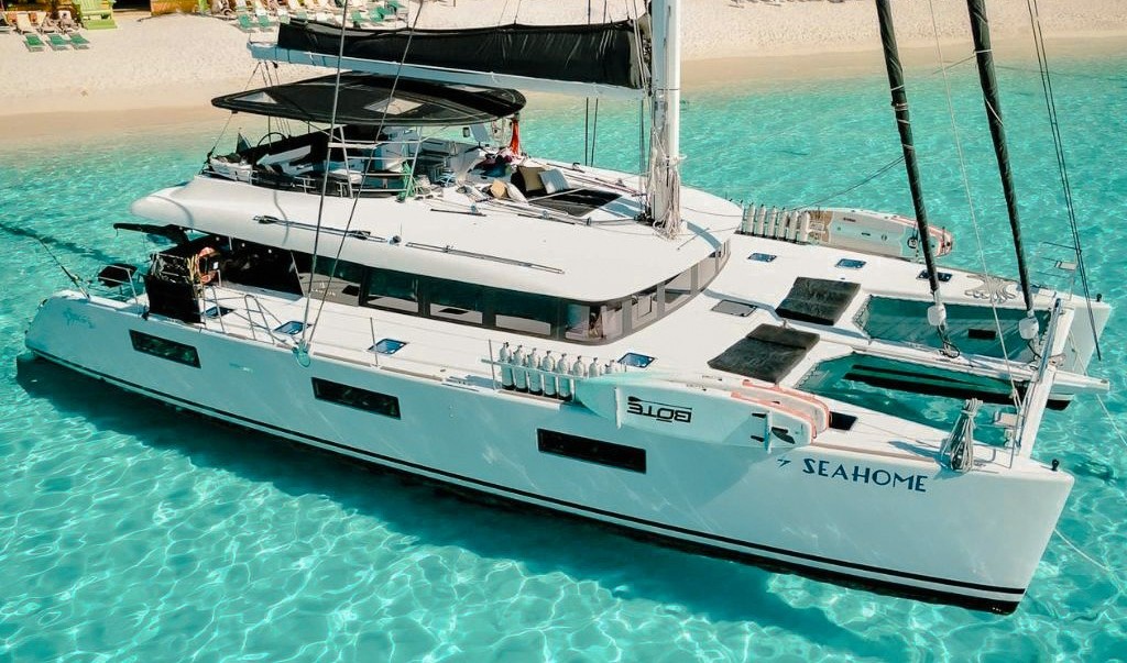 Stunning 63ft Lagoon yacht sailing on turquoise Caribbean waters, perfect for luxury boat charters.