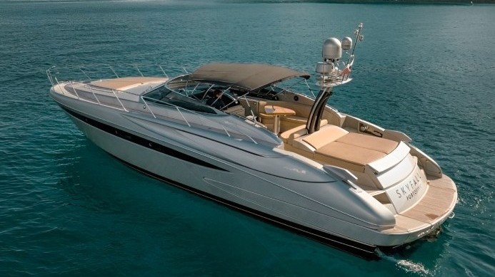 Luxury 52ft Riva Rivale yacht cruising on the Italian coast, showing spacious deck and sea breeze.