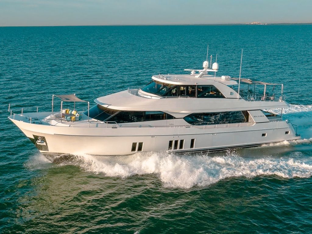 Side view of the 100 Ocean Alexander yacht at anchor in The Bahamas