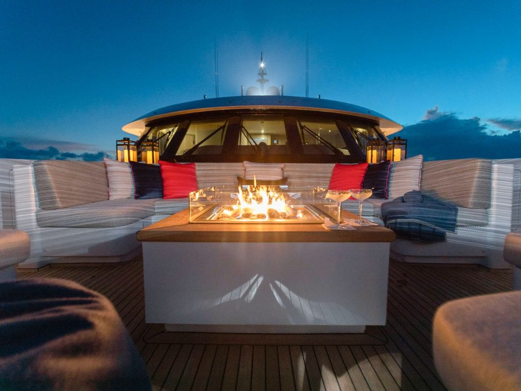 A private yacht docked at a marina with buildings in the background