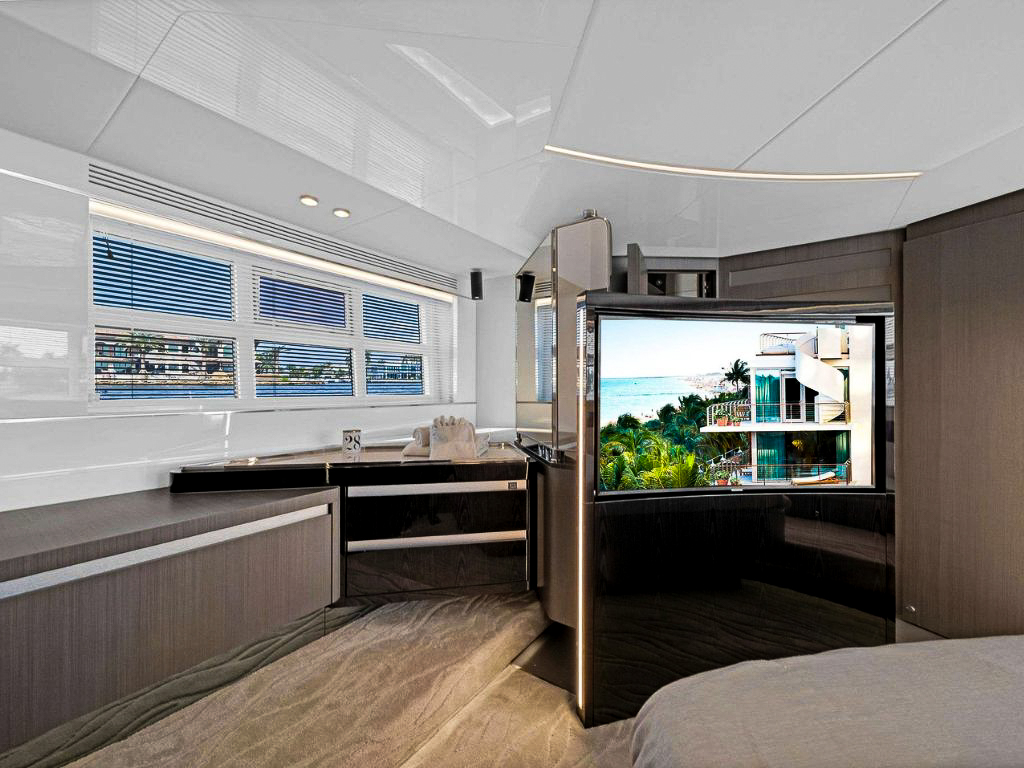 View of the 70 Azimut IV yacht's aft deck with dining table and seating overlooking the ocean